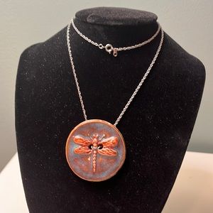 N73. Dragonfly pendant on silver colored chain.